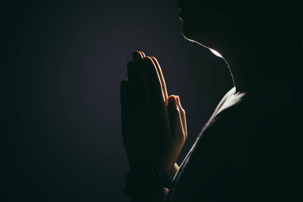 Prayer woman hand Hands folded in prayer in church concept for faith, spirituality and religion, woman praying on holy bible in the morning. christian social union photos stock pictures, royalty-free photos & images
