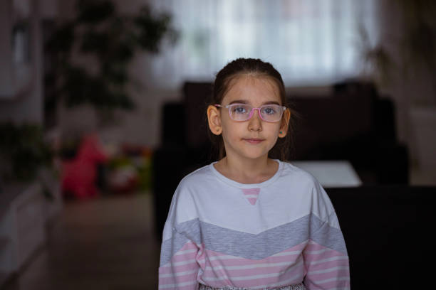 Front view of smart girl with eyeglasses at her home