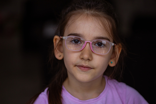 Intelligent little girl wearing eyeglasses