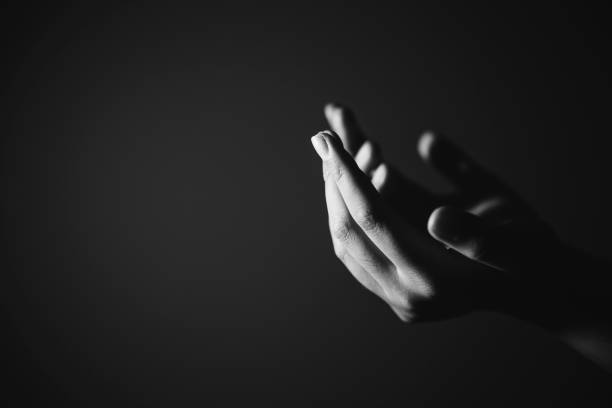 Black and white prayer hands Religion, belief, worship concept copy space: Black and white prayer hands with palms up to pray God church black and white people praying stock pictures, royalty-free photos & images