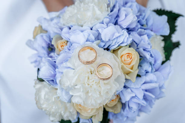 istock Wedding rings on a bouquet of roses 1400224627