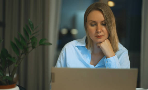 istock Pretty woman using laptop at home. 1400226295
