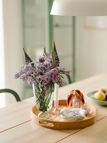 Table setting decor with bouquet of lilacs and tray
Modern contemporary home setting decor