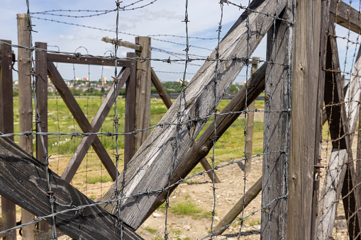 Majdanek; Lublin; Poland - May 25, 2022: Majdanek concentration and extermination camp ( Konzentrationslager Lublin), view of barbed wire fence. It was a Nazi camp built and operated by the SS during the German occupation of Poland in World War II