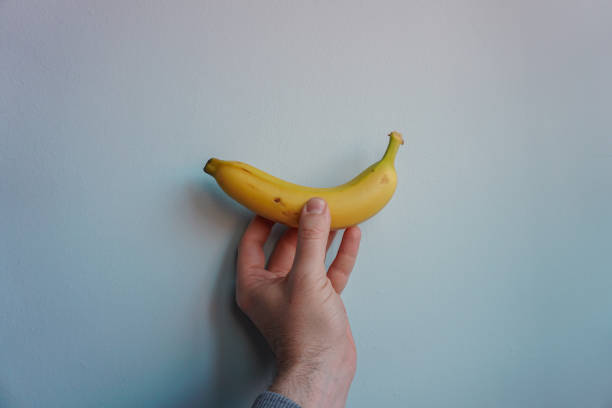 istock hand holding a banana, healthy fruit 1400227761