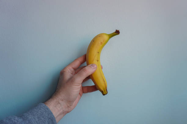 istock hand holding a banana, healthy fruit 1400228318