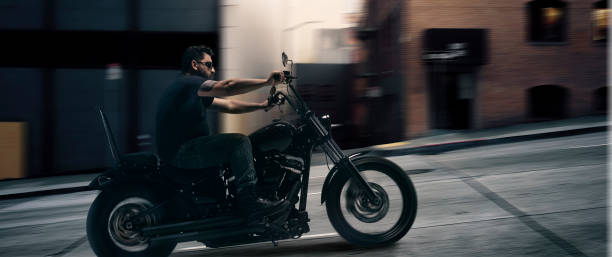 istock Serious brutal biker rushes on a motorcycle through the evening metropolis. Unfocus effect. Concept of fashion, style and hobby, aspiration 1400228454