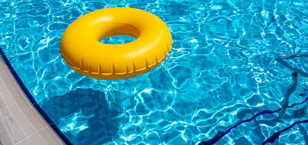 istock Yellow ring floating in refreshing blue swimming pool 1400229851