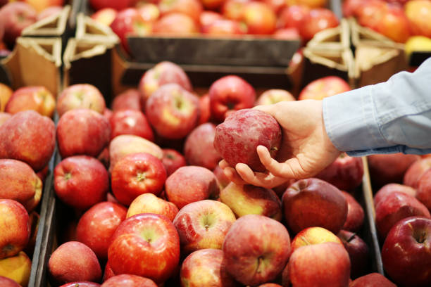 istock Man buying apples at the market 1400230090