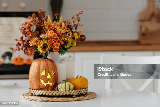 A Vase Of Flowersa Jack Pumpkin And Candles On A Tray In The Background The Interior Of A White Kitchen In Scandi Style The Concept Of Home And Comfort Autumn Decor For The Halloween Holiday Stock Photo - Download Image Now
