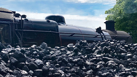 Steam Train standing next to a Coal Bunker