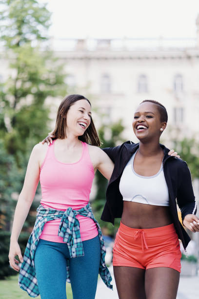 istock Two multiethnic girls walking for a exercise session, outdoor communicating. 1400238258