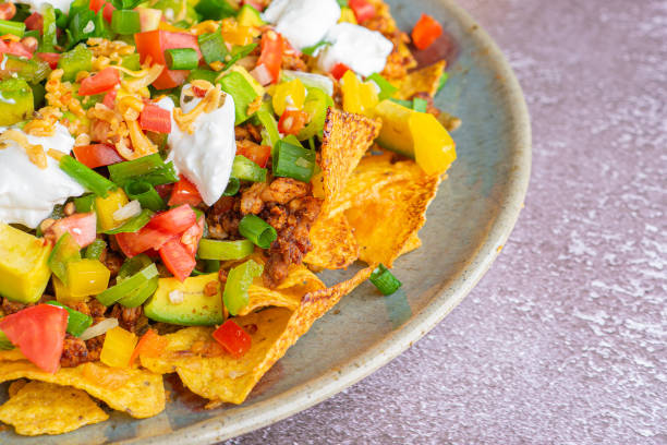 istock Top view of loaded minced pork nachos on stone background 1400240534