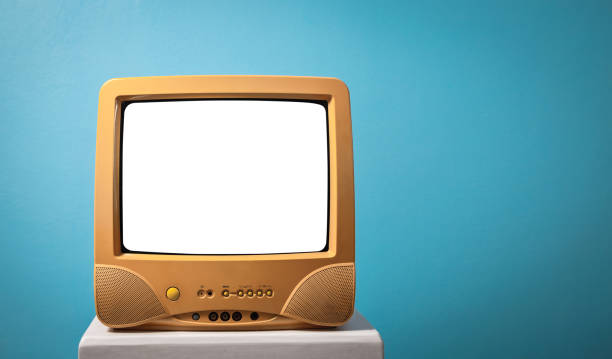 istock classic, retro yellow old television receiver with blank screen on white wooden box with mint blue background. 1400241096