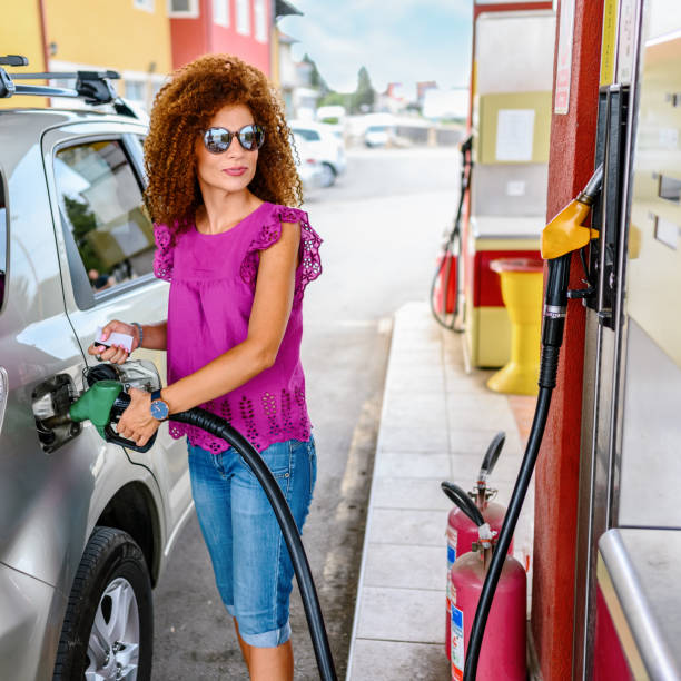 istock Young woman refuel the car 1400242324