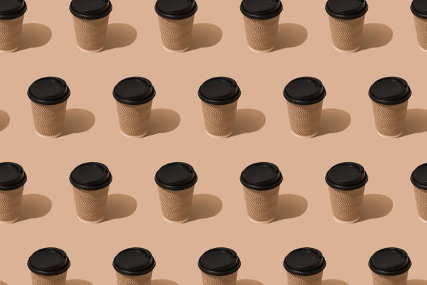 istock Pattern with eco paper brown coffee cups with black plastic lids over light brown background, mockup image. Sustainable food packaging concept 1400246924