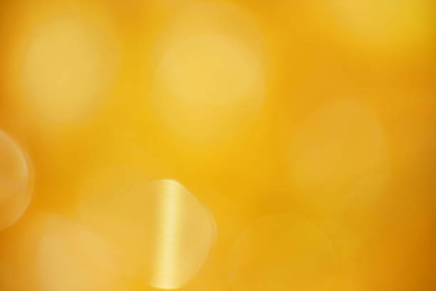 istock blurry golden shiny light background and texture 1400247400
