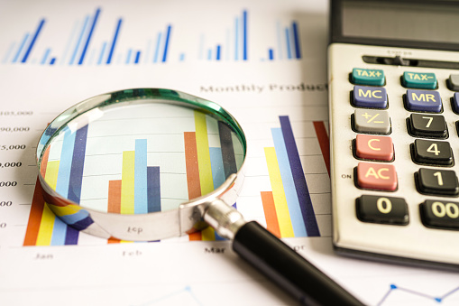 Magnifying glass on charts graphs paper. Financial development, Banking Account, Statistics, Investment Analytic research data economy.