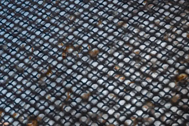 Metal grid silhouette against rusty plate. Background image