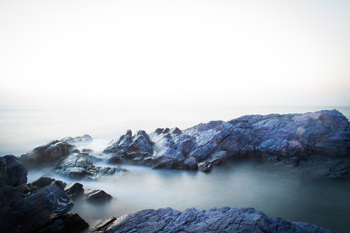 Sea landscape with rocks and fog