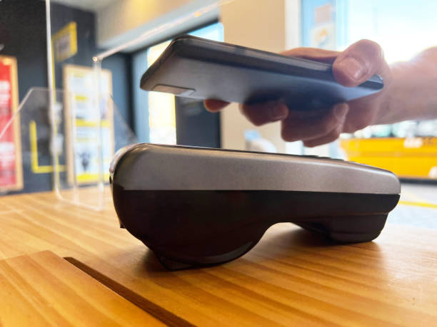 istock Hand with mobile to pay in the store 1400251044