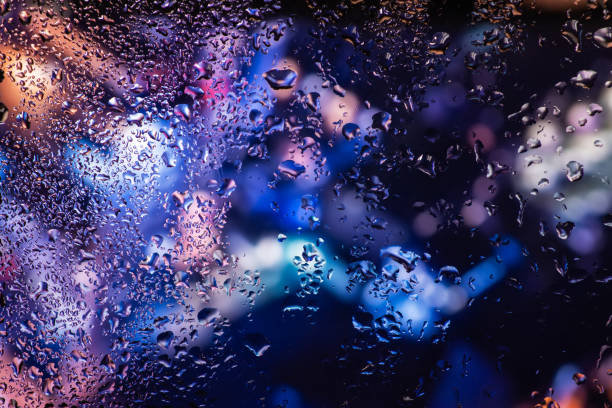 istock Condensation on the clear glass window. Water drops. Rain. Abstract background texture 1400251595