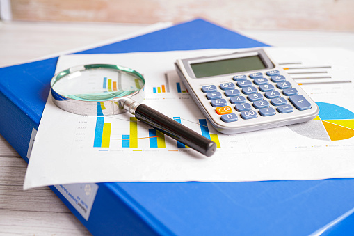 Magnifying glass on charts graphs paper. Financial development, Banking Account, Statistics, Investment Analytic research data economy.