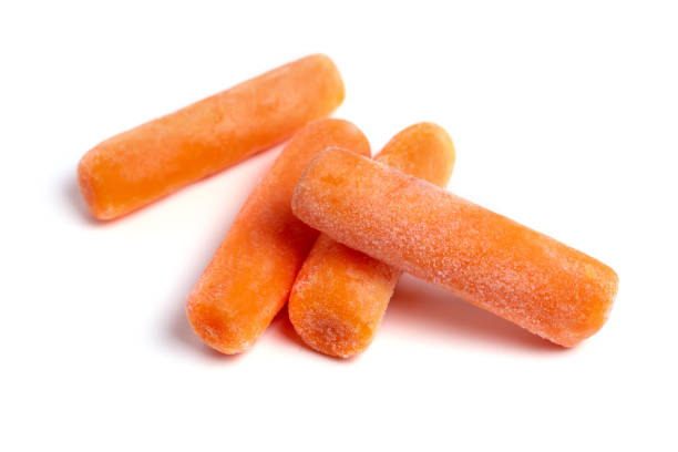 istock Baby frozen carrots on a white background 1400254148