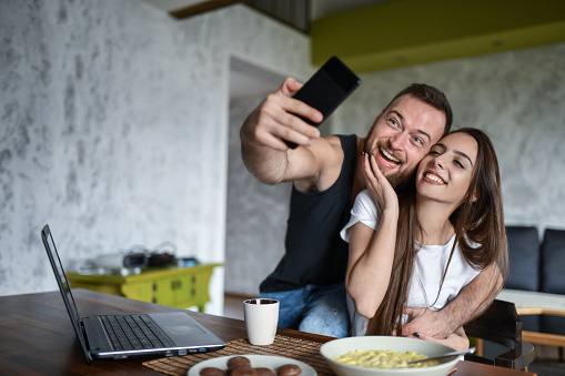 Selfie Time For Smiling Couple Embracing During Breakfast Time