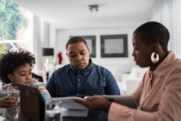 istock Professional consultant talking to customer and his daughter during home visit 1400256723