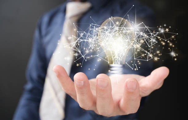 istock Hands holding a light bulb to represent an idea notion with innovation and inspiration, inventive scientific technology, and innovative idea Perspective and networking On a global network connection 1400256920