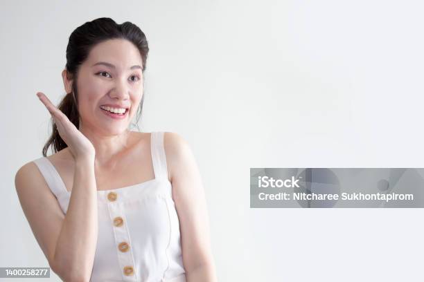 Asian Beautiful Woman Raise A Hand Beside Her Face Are Smiling With Happiness Good Healthy And Mental Stock Photo - Download Image Now