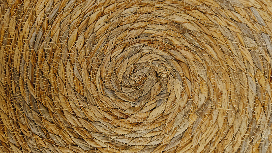 full frame background of spiral motif of a straw basket