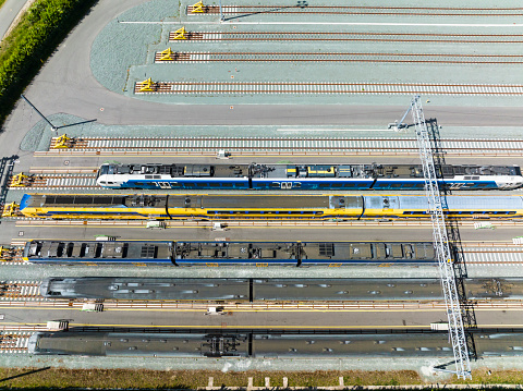 Railroad yard in Zwolle at the Engelse Werk park seen from above during a beautiful summer day. Trains are stationary at the yard for various lines in Overijssel.