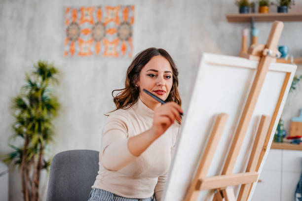 istock Young Female Artist Panting At Home 1400259760