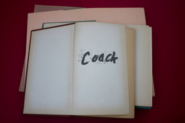 istock Coach word in opened book with vintage, natural patterns old antique paper design. 1400259865