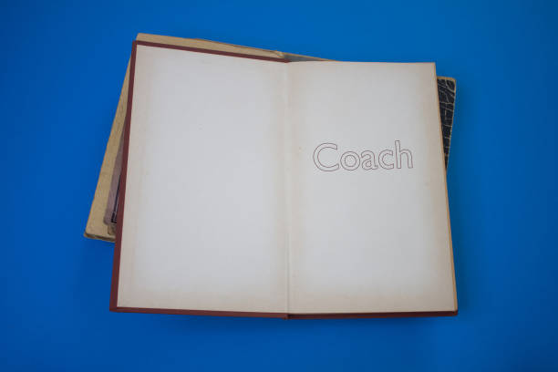 istock Coach word in opened book with vintage, natural patterns old antique paper design. 1400259902