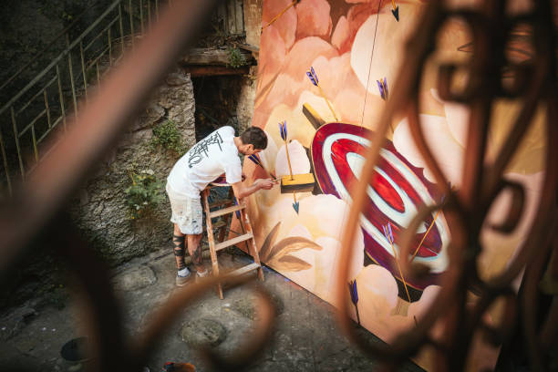 Male artist working on a big painting. Creative occupation concept.