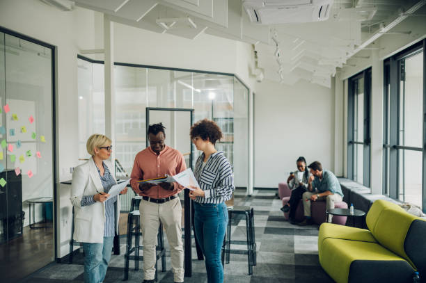 istock Multiracial business colleagues discussing about documents in the office 1400261147