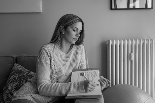 Black and white photography of woman taking notes