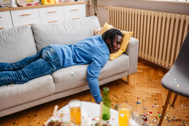 istock Young Black Man With Hangover Waking Up After A Birthday Party 1400265404