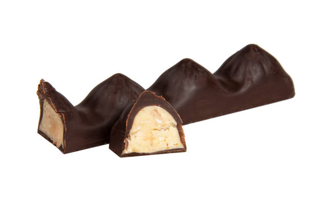 istock Chocolate sweet candy with nut glazed in half isolated on the white background 1400265841