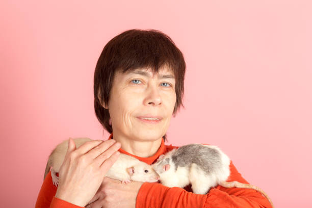 istock woman with two domestic rats 1400266004