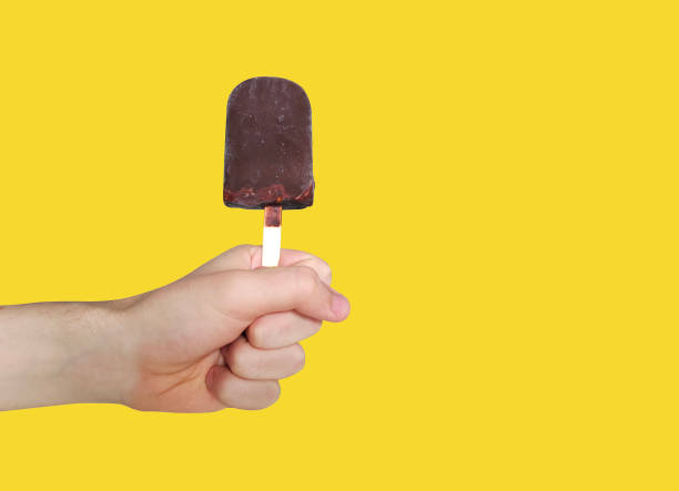 istock Chocolate ice-cream isolated on white background. Popsicle in male hand. 1400266071