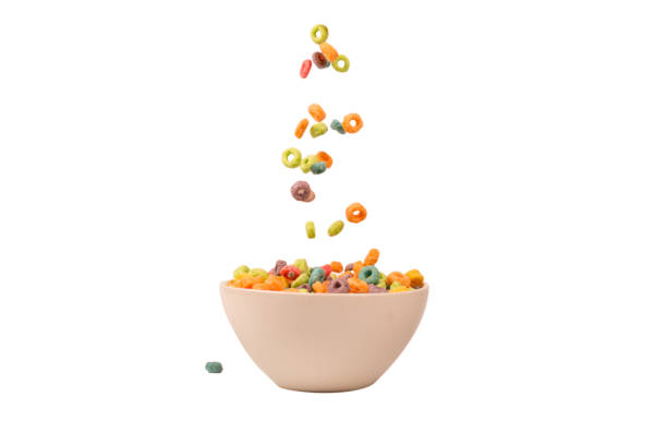 Colorful cereal box for morning breakfast. Corn flakes falling to the white bowl. Motion.