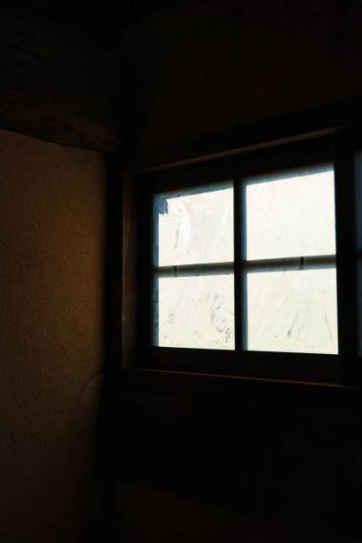 istock A frosted glass window seen from inside a pitch-black room 1400267461