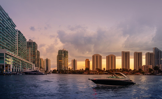 Small boat arriving to pier with Sunny Isles skyline in the back