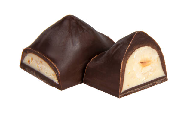 istock Chocolate sweet candy with nut glazed in half isolated on the white background 1400267642