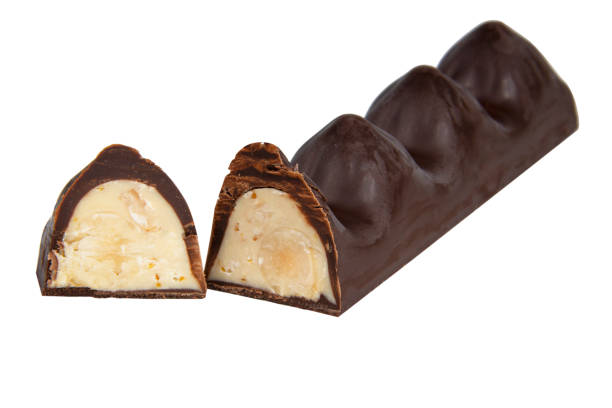 istock Chocolate sweet candy with nut glazed in half isolated on the white background 1400267676