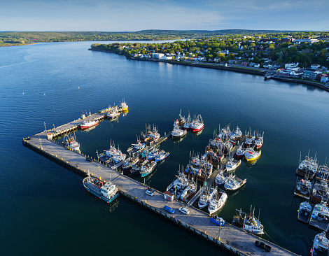 Aerial drone view of a scallop fishing fleet & wharf.